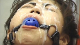 Asians tied up with ball gags getting bukkake cumshots to their faces.