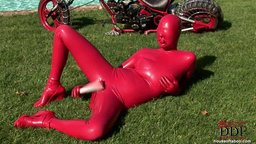 Busty Sandy toying pussy & ass covered with latex outdoors